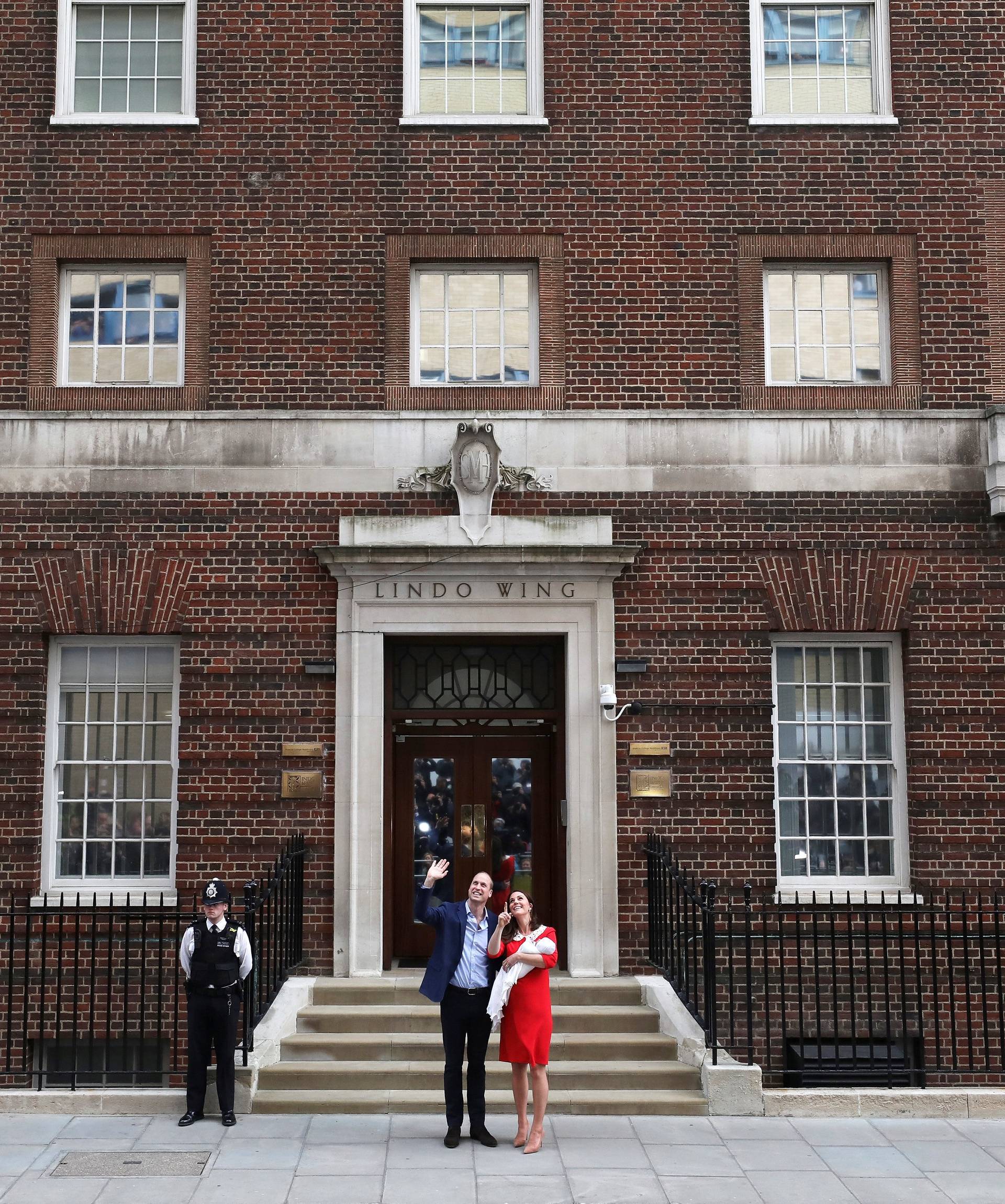 Britain's Catherine, the Duchess of Cambridge and Prince William leave the Lindo Wing of St Mary's Hospital with their new baby boy in London