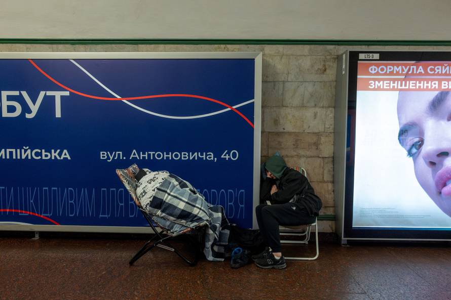People take shelter in a metro station during Russian drone and missile strikes in Kyiv