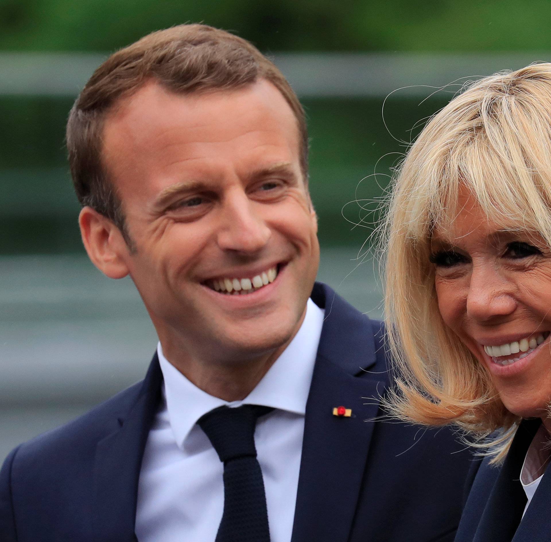 French President Emmanuel Macron and his wife Brigitte Macron arrive at the French national football team training center in Clairefontaine near Paris