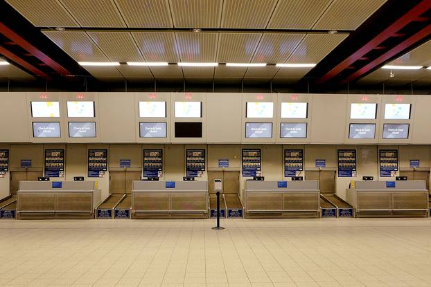 Check-in desks stand empty in the Monarch flights departures area after the airline ceased trading, at Luton airport, Britain
