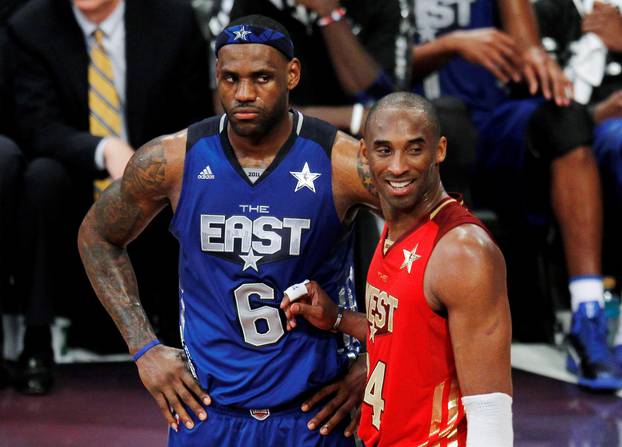 FILE PHOTO: West All Star Bryant of the Lakers stands with East All Star James of the Heat near the end of the NBA All-Star basketball game in Los Angeles