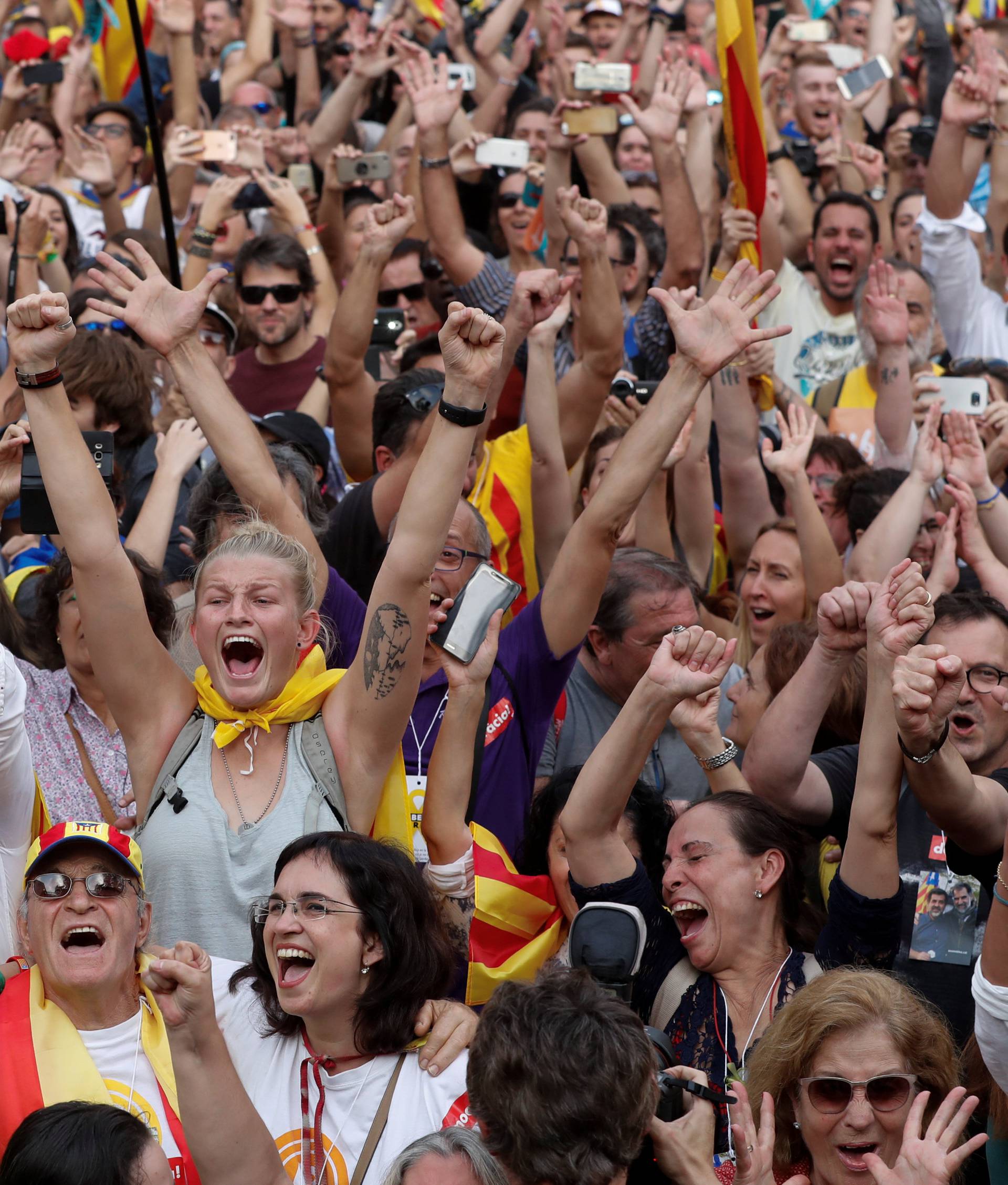 People celebrate after the Catalan regional parliament passes the vote of the independence from Spain in Barcelona