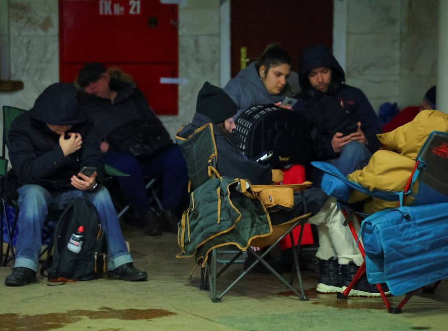People take shelter inside a metro station during a Russian missile and drone attack in Kyiv