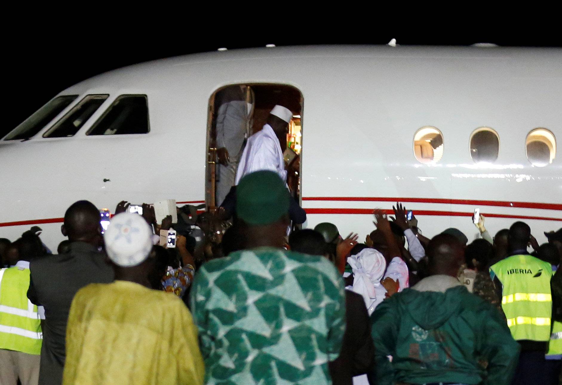 Former Gambian President Yahya Jammeh boards a plane at the airport as he flying into exile from Gambia