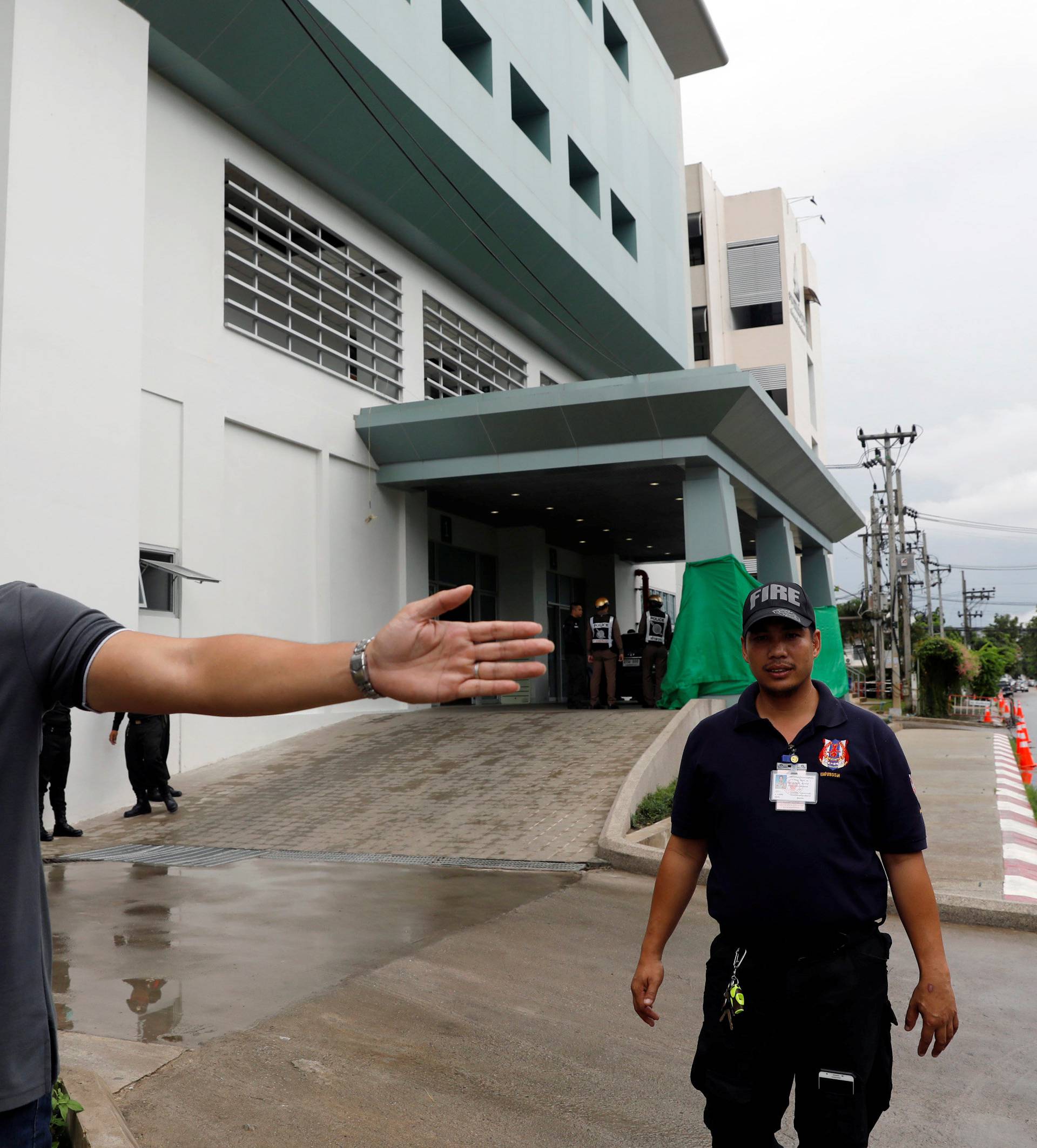 Officers clear the area in front of Chiang Rai hospital where the 12 schoolboys and their soccer coach tapped inside a flooded cave, will get treatment, in the northern province of Chiang Rai