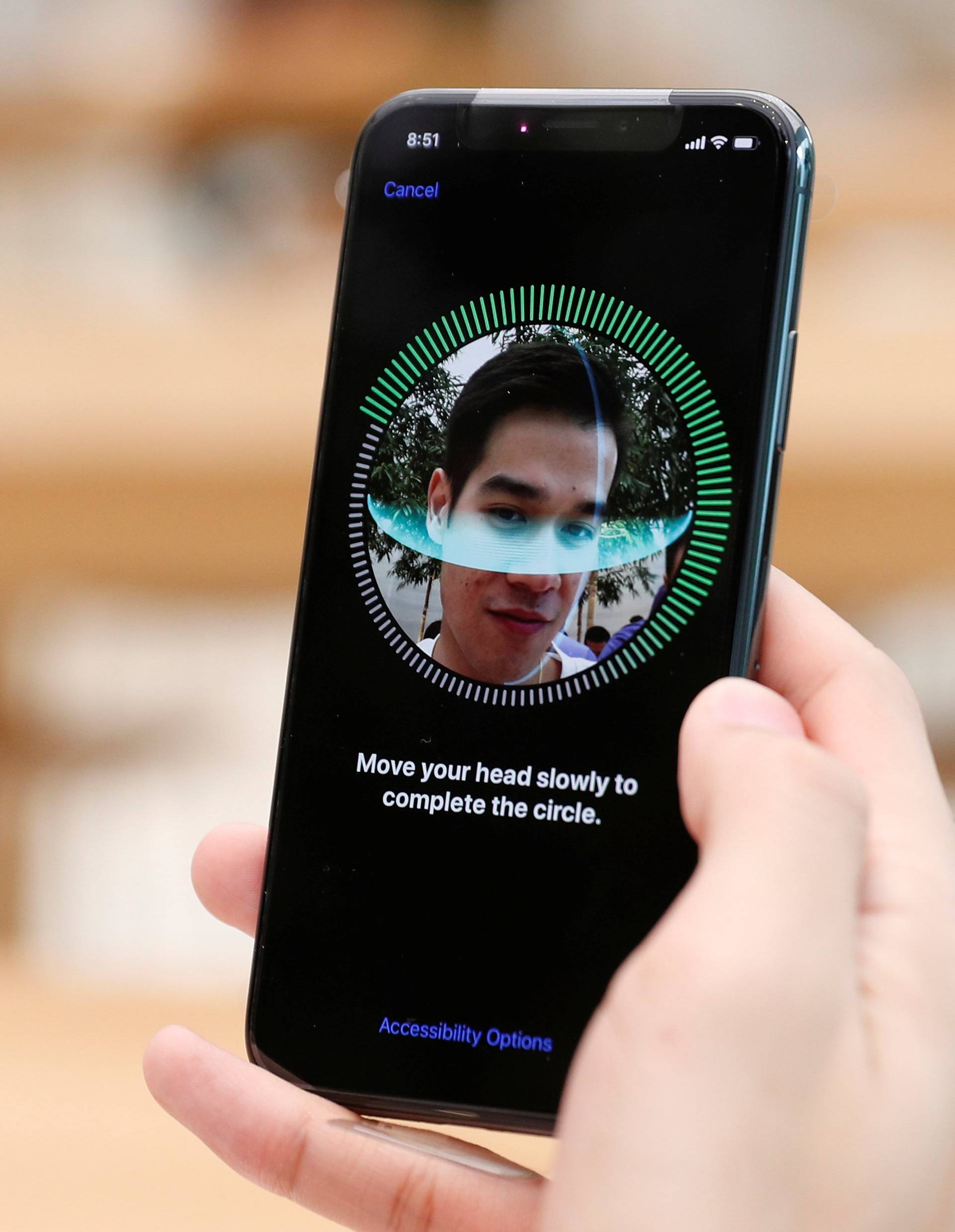 A customer sets up his iPhone X Face ID during its launch at the Apple store in Singapore