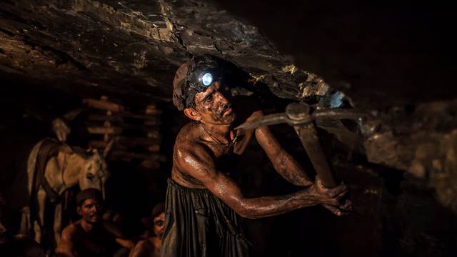 Miner Mohammad Ismail digs in a coal mine in Choa Saidan Shah, Punjab province