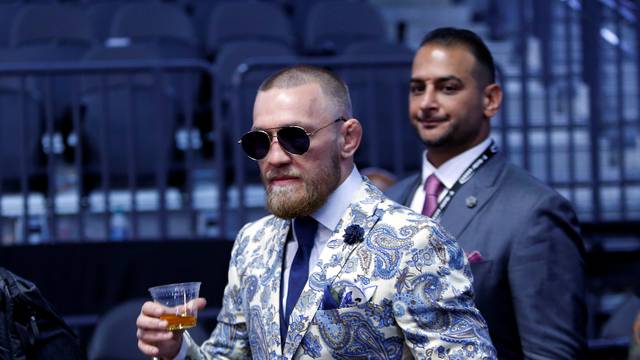 UFC lightweight champion Conor McGregor of Ireland arrives for a post-fight news conference at T-Mobile Arena in Las Vegas