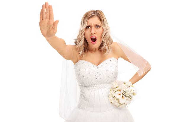 Displeased bride making a stop hand gesture 