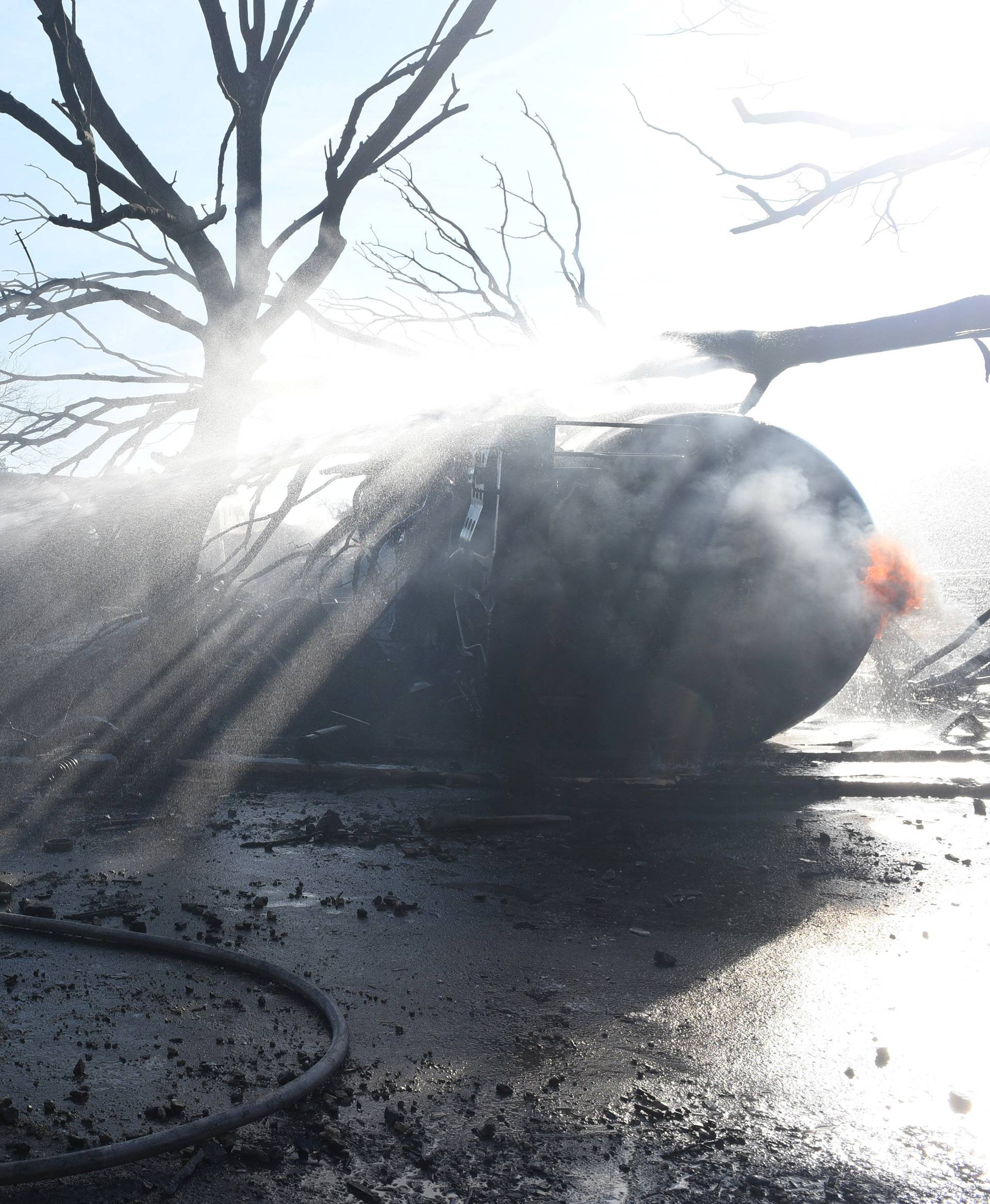 Firefighter works on the site where a cargo train derailed and exploded in the village of Hitrino