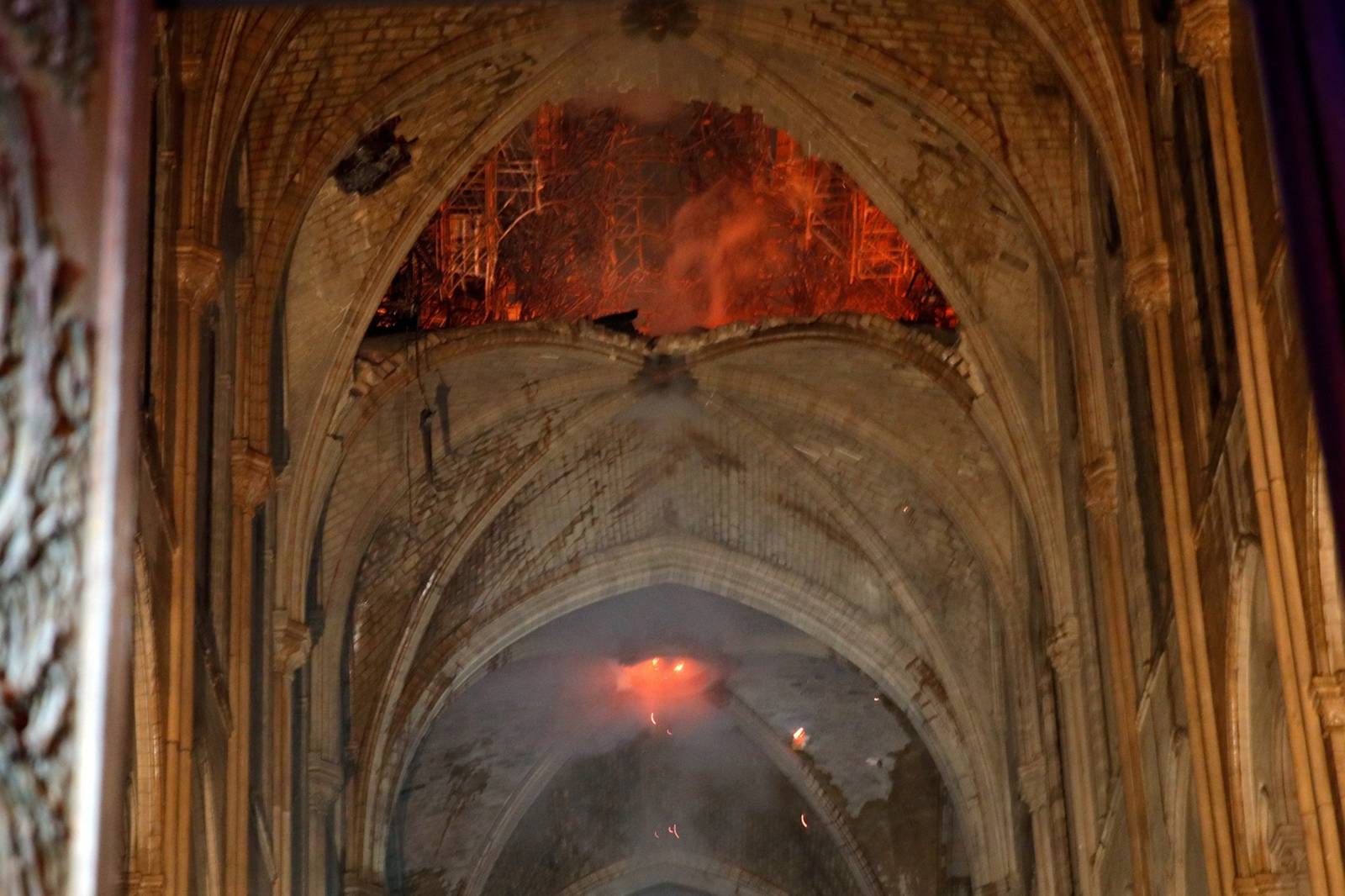 Flames are seen as the interior continues to burn inside the Notre Dame Cathedral in Paris