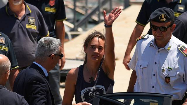 FILE PHOTO: Carola Rackete, the 31-year-old Sea-Watch 3 captain, disembarks from a Finance police boat and is escorted to a car, in Porto Empedocle