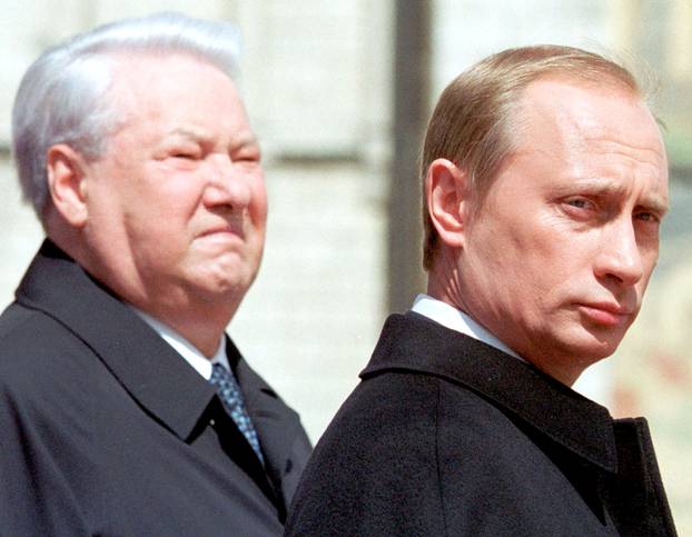 FILE PHOTO: The first Russian president Boris Yeltsin (L) stands with President Vladimir Putin