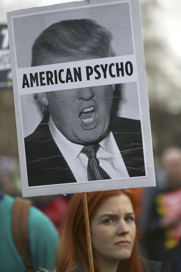 A demonstrator holds a placard during a march against U.S. President Donald Trump in London