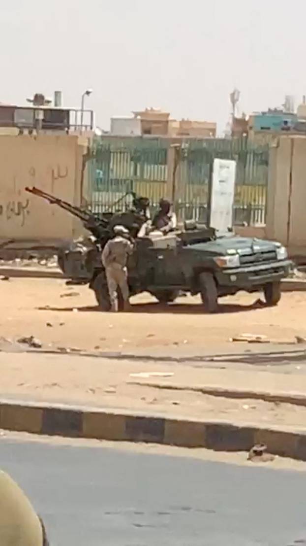 Military vehicle and soldiers on a street of Khartoum
