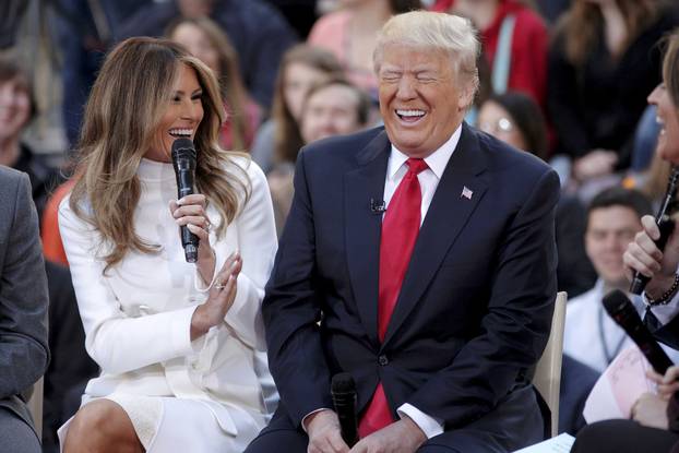 U.S. Republican presidential candidate Donald Trump reacts to an answer his wife Melania gives during an interview on NBC