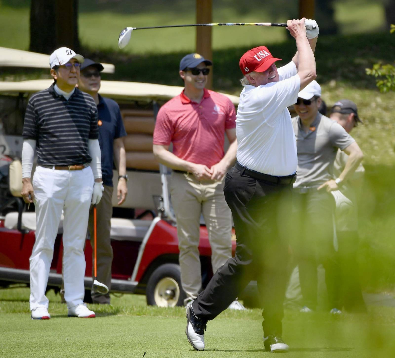 U.S. President Donald Trump and Japan's Prime Minister Shinzo Abe play golf at Mobara Country Club in Mobara, Chiba prefecture, Japan