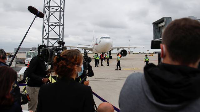 People who have been evacuated from Afghanistan arrive at Roissy Charles-de-Gaulle airport, in Paris