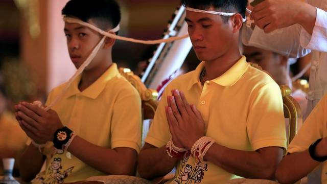 Members of a soccer team rescued from a cave attend a religious ceremony, in a temple at Mae Sai, in the northern province of Chiang Rai