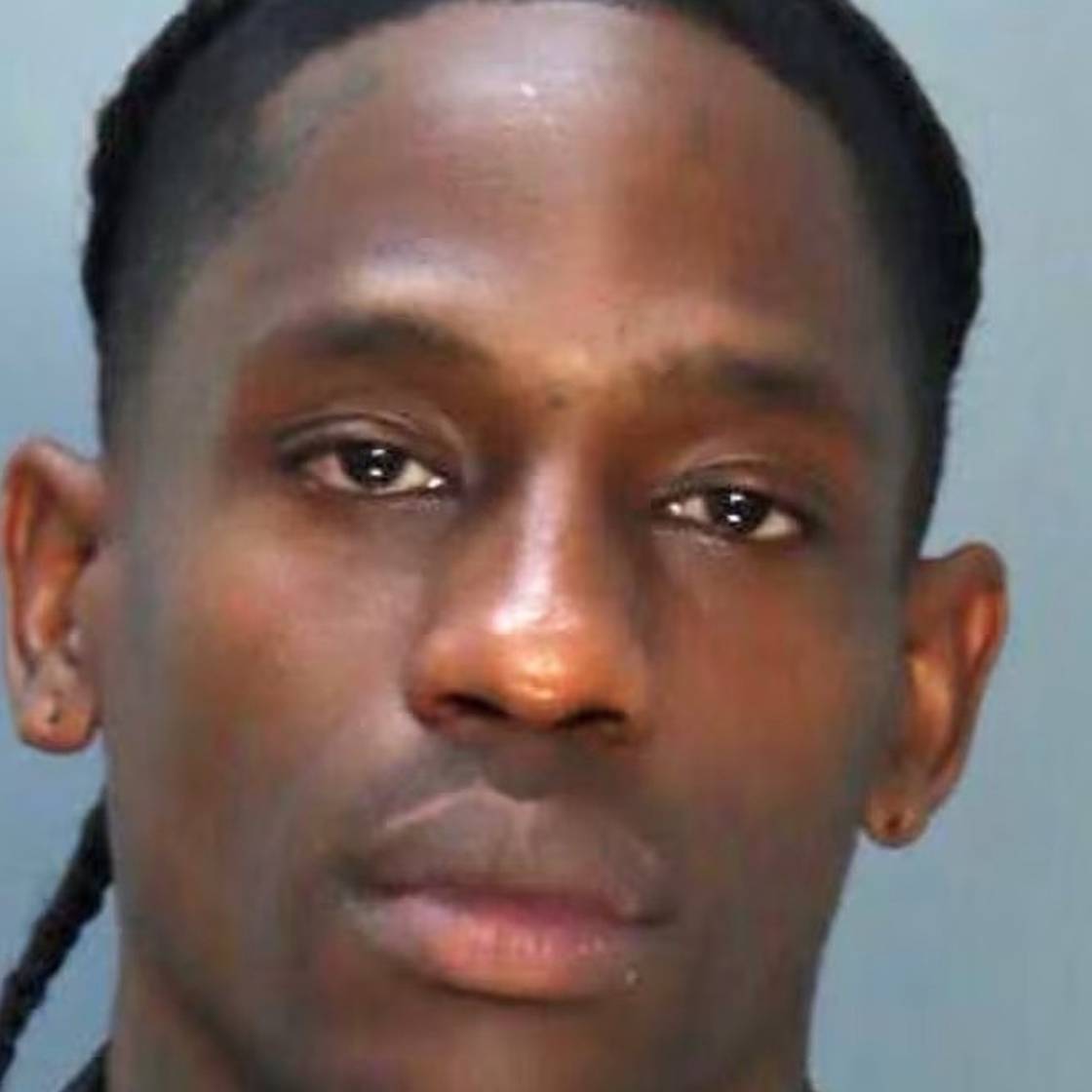 Travis Scott poses for a mugshot after being arrested in Miami