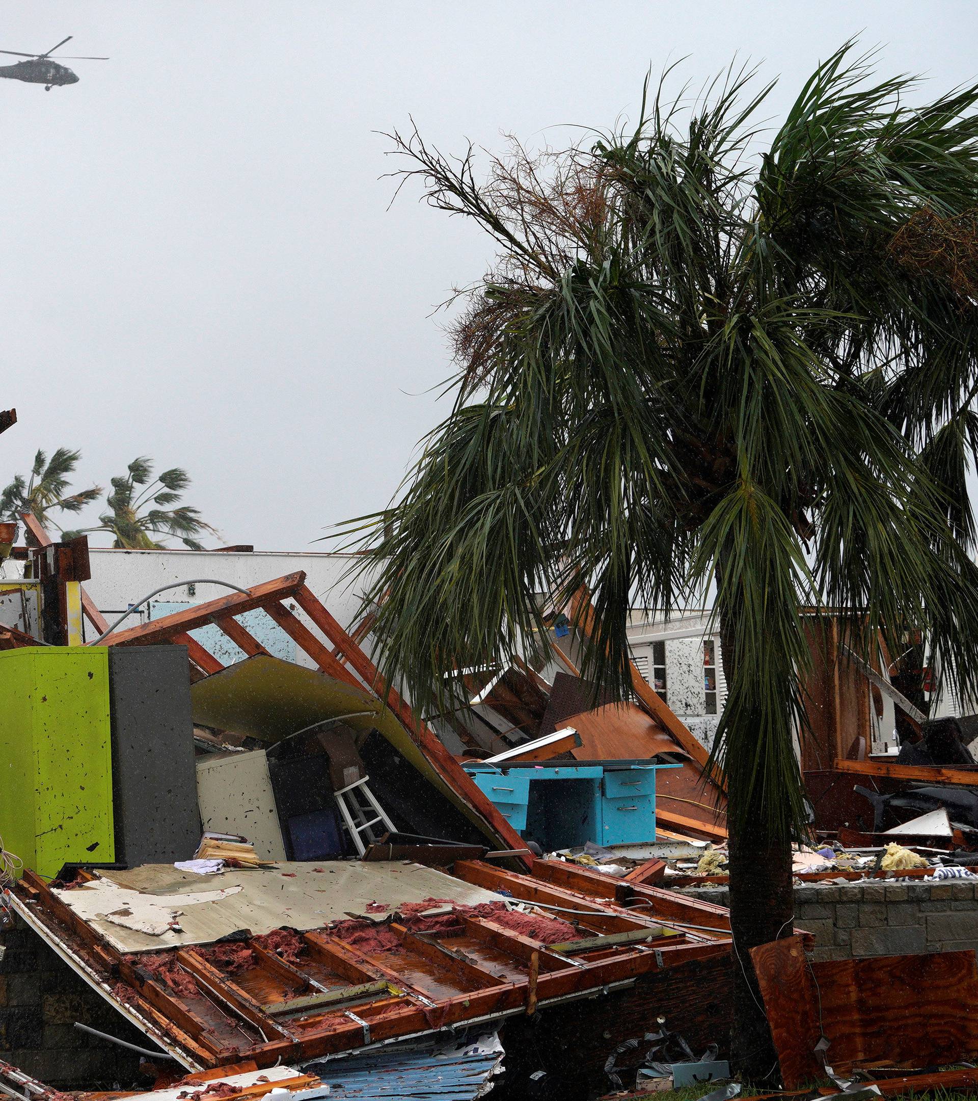 FILE PHOTO: A military helicopter flies over a destroyed house after Hurricane Harvey struck in Rockport