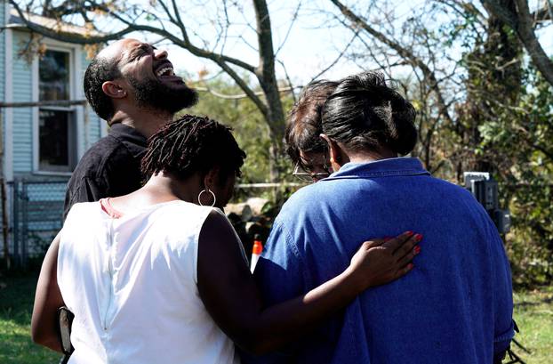 Pastor Oscar Dean prays with others near the site of the shooting at the First Baptist Church of Sutherland