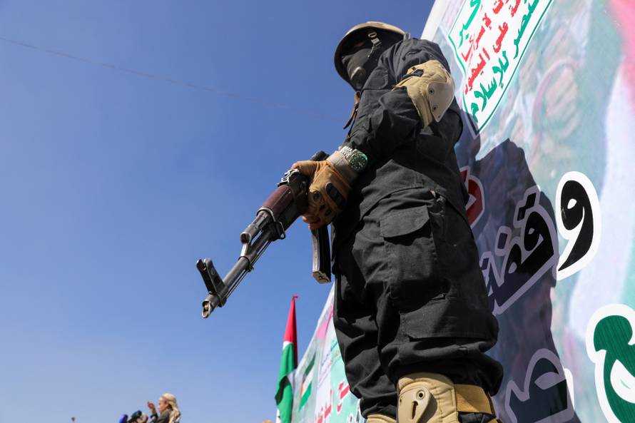 A Houthi fighter stands guard during a ceremony at the end of the training of newly recruited Houthi fighters in Sanaa