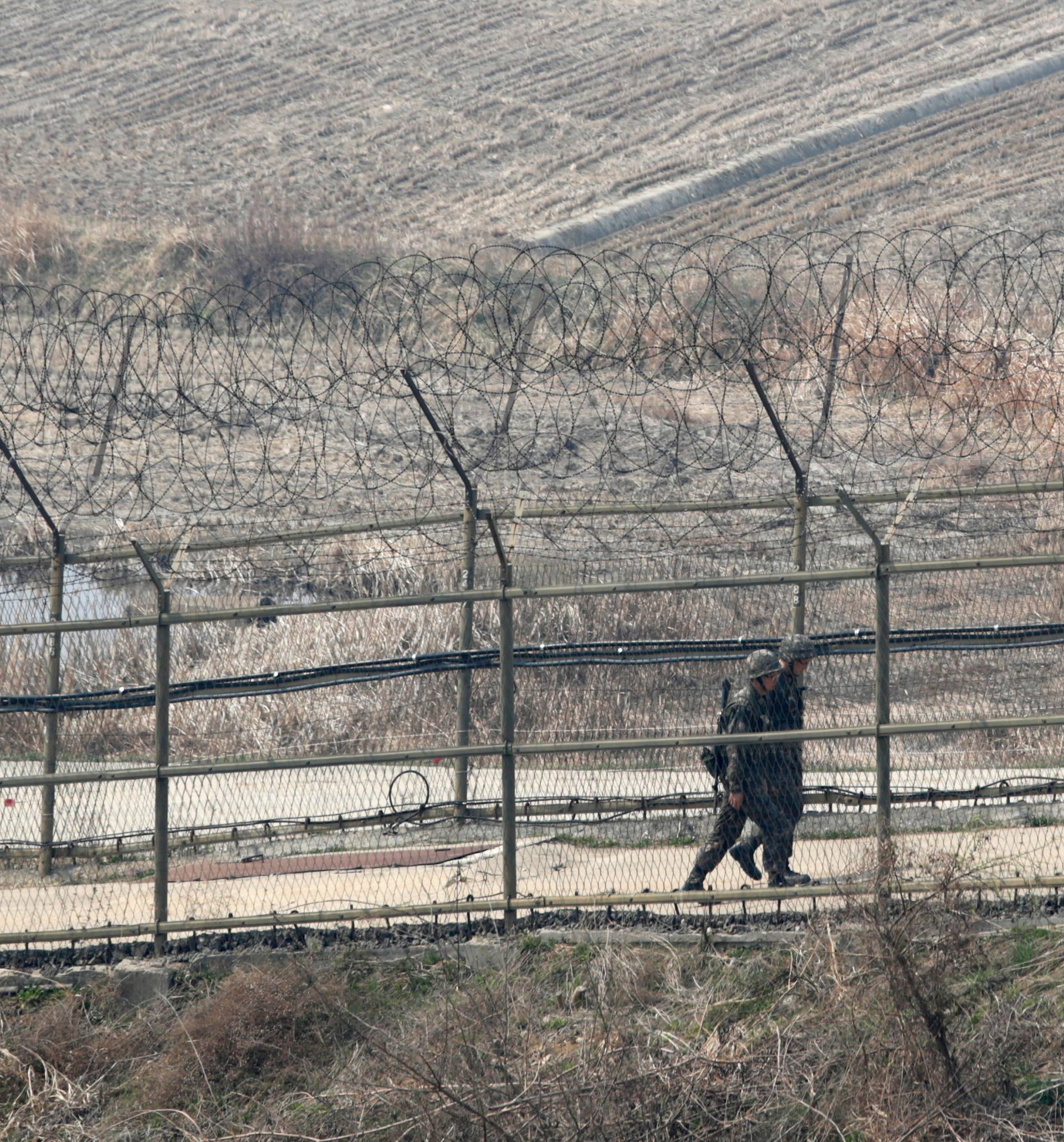 Paju, South Korea. 1st April 2014. South Korean soldiers patrol along the military fences near DMZ, Paju, South Korea, on Tuesday April 1, 2014. North and South Koreas exchanged artillery fire across the western maritime border, the Northern Limit Line (N