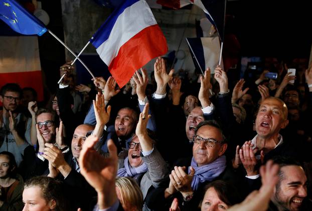 Supporters of Emmanuel Macron celebrate after the second round of 2017 French presidential election, in Lyon