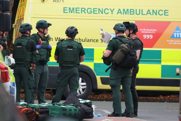 Police officers work at the scene following an incident outside a synagogue, in Manchester
