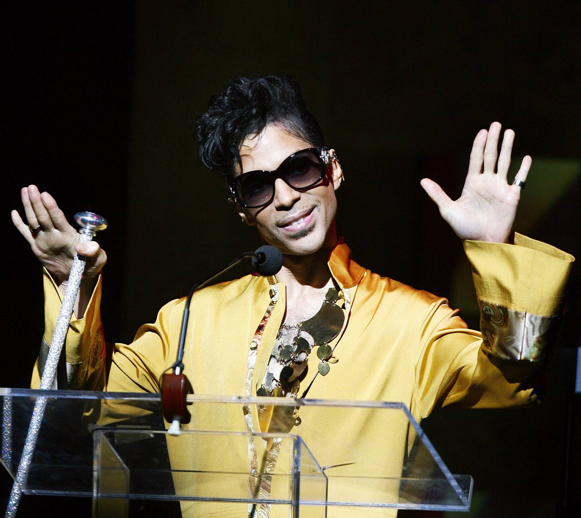 Musician Prince gestures on stage during Apollo Theatre's 75th anniversary gala in New York