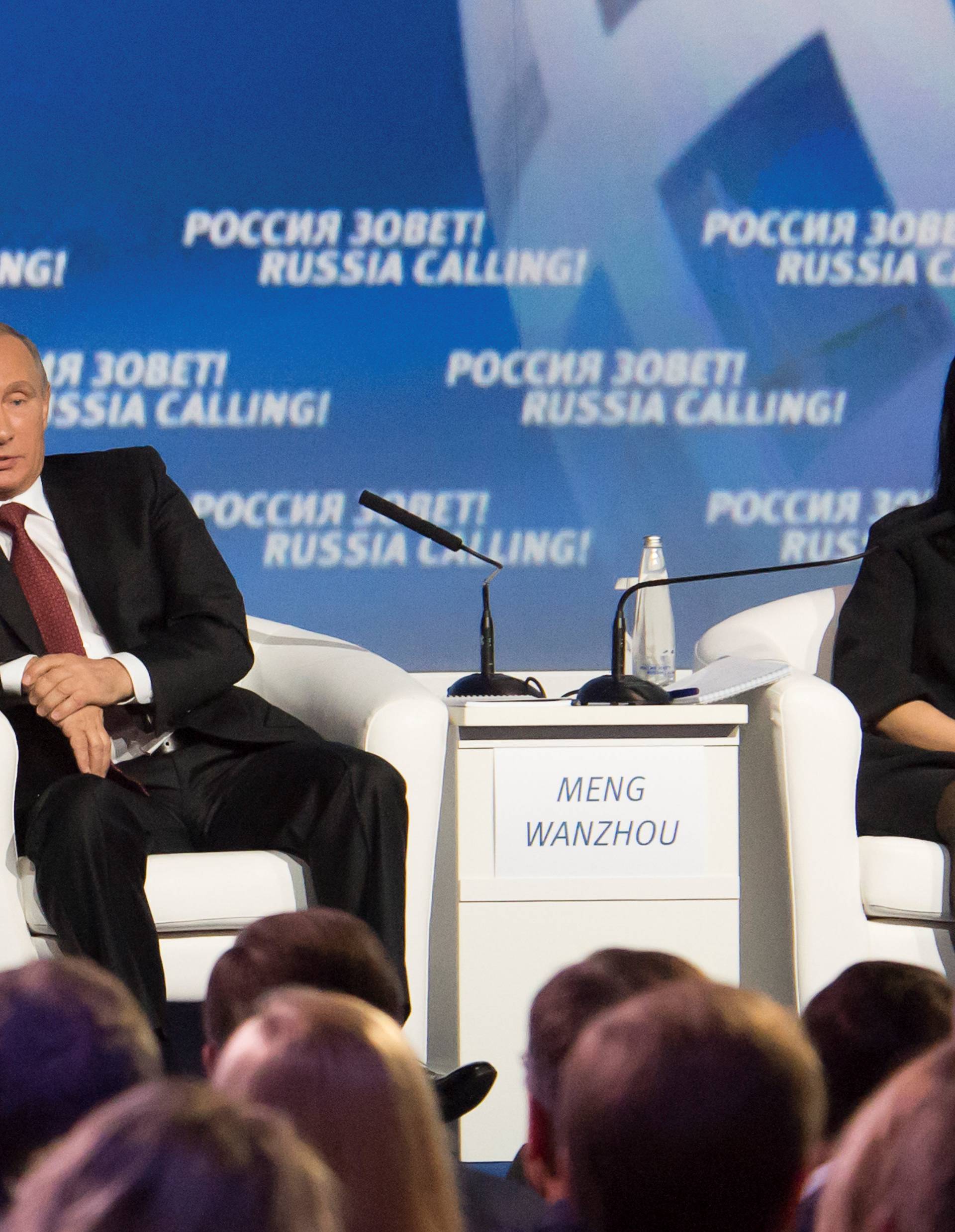 Russia's President Vladimir Putin and Huawei's Executive Board Director Meng Wanzhou attend the VTB Capital Investment Forum "Russia Calling!" in Moscow