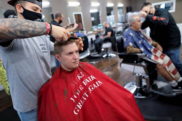 FILE PHOTO: Aaron Schumacher, 33, of Staten Island has his hair cut at Craig & Pop