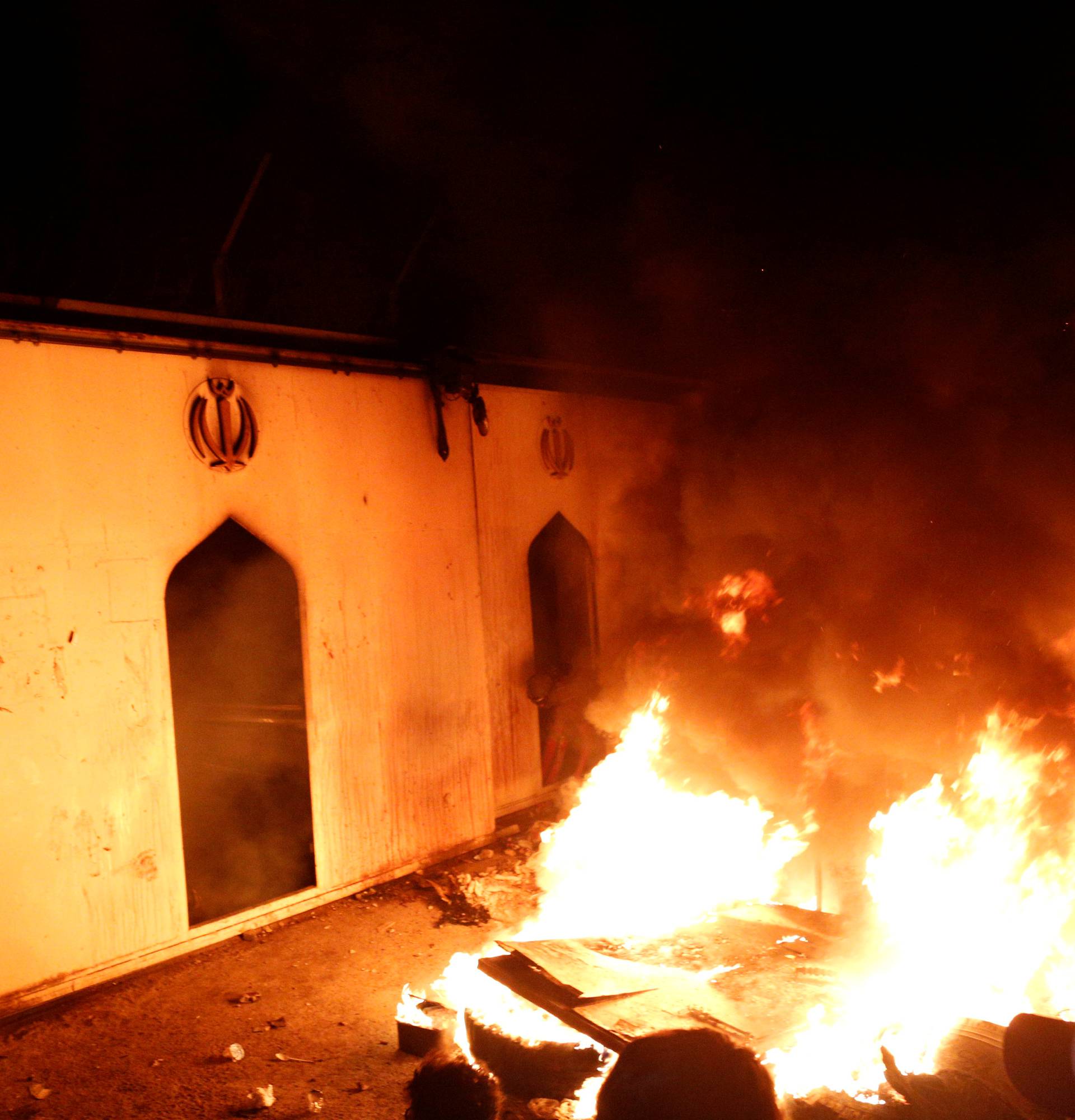 Demonstrators set fire in front of the Iranian consulate, as they gather during ongoing anti-government protests in Najaf
