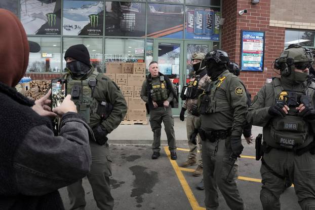 Border Patrol commander Greg Bovino's convoy stops at a gas station in Columbia Heights
