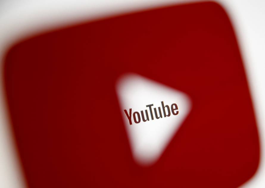 FILE PHOTO:    A 3D-printed YouTube icon is seen in front of a displayed YouTube logo in this illustration