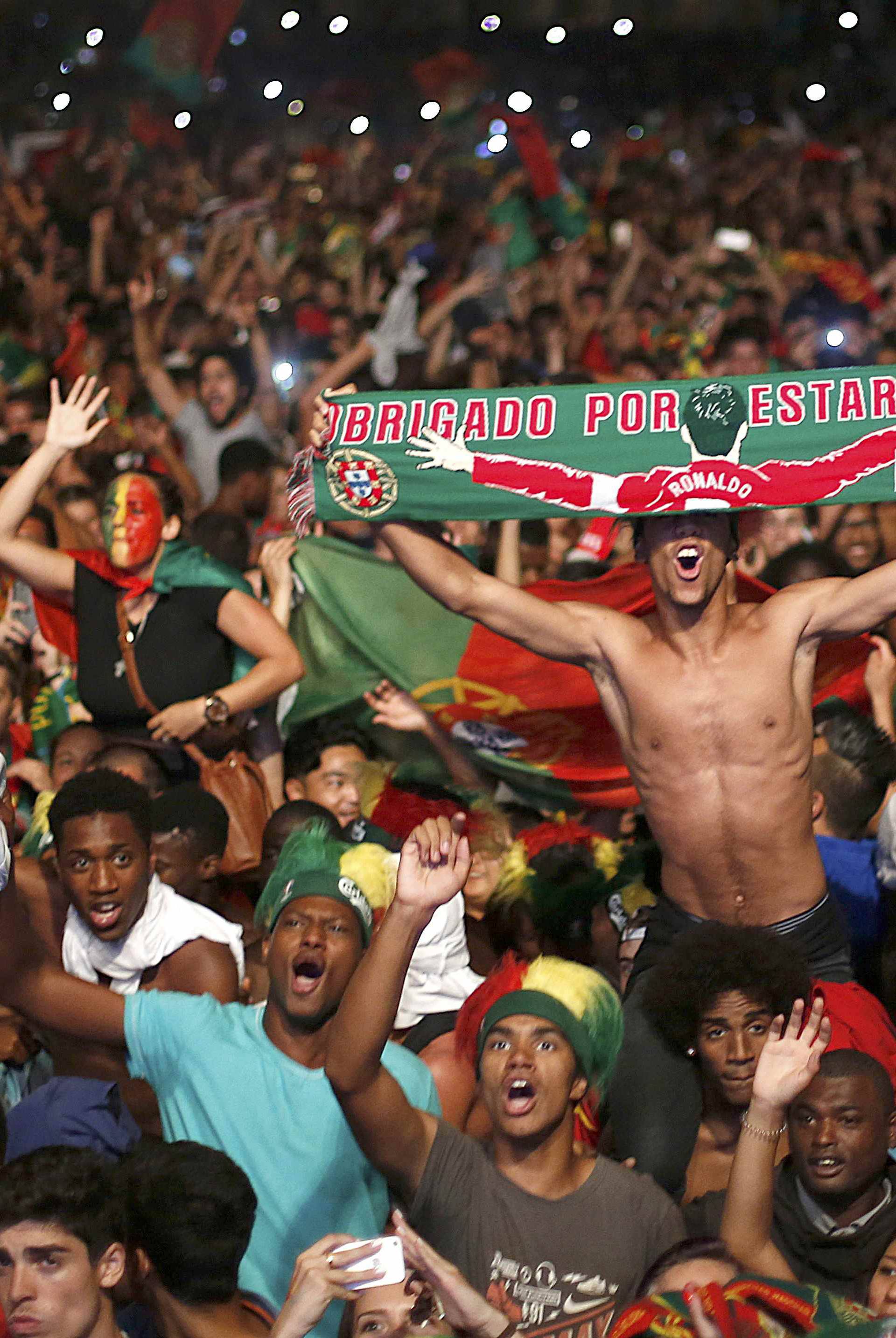 Fans of Portugal react as they watch the Euro 2016 final between Portugal and France at a public screening in Lisbon