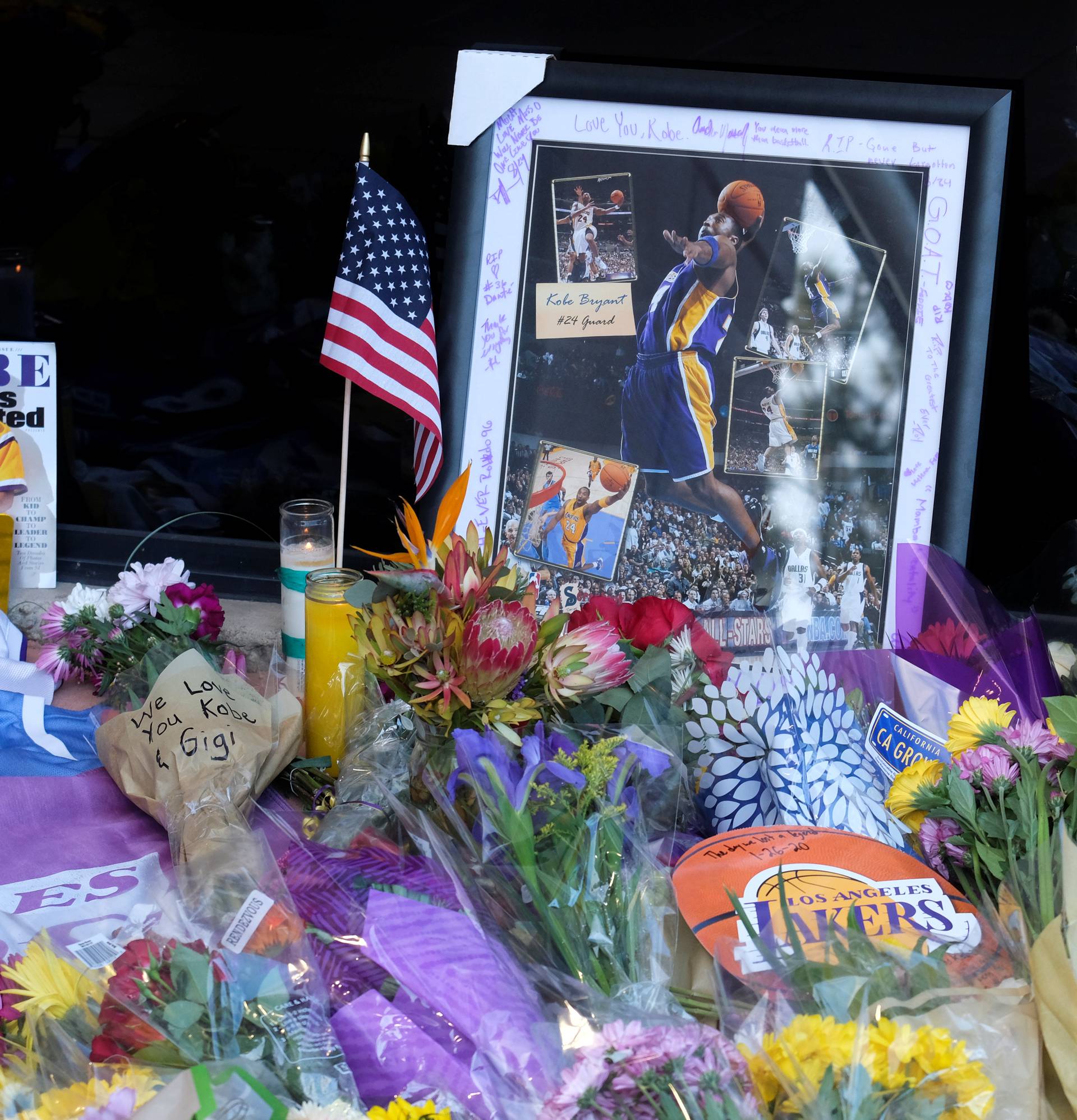 Flowers, photos and messages are placed at a makeshift memorial for former NBA player Kobe Bryant outside of the Mamba Sports Academy in Thousand Oaks