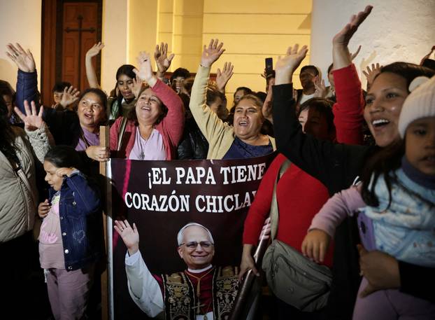 People react at the Cathedral of Saint Mary, on the day of the election of Pope Leo XIV, in Chiclayo