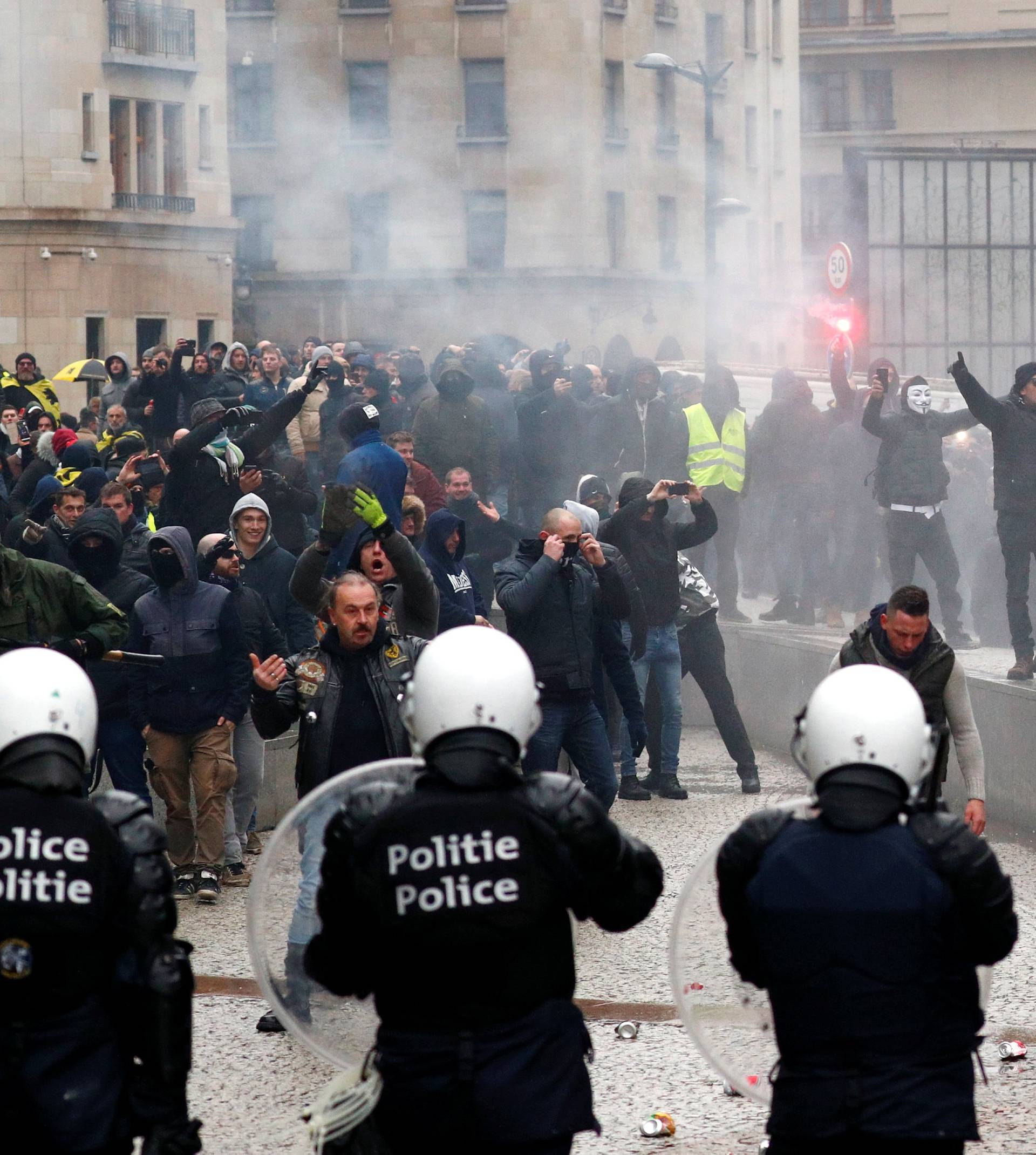 Far-right supporters face off with police during a protest against Marrakesh Migration Pact in Brussel