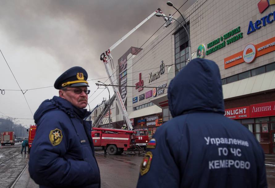 Members of the Emergency Situations Ministry work at the scene of a fire in a shopping mall in Kemerovo