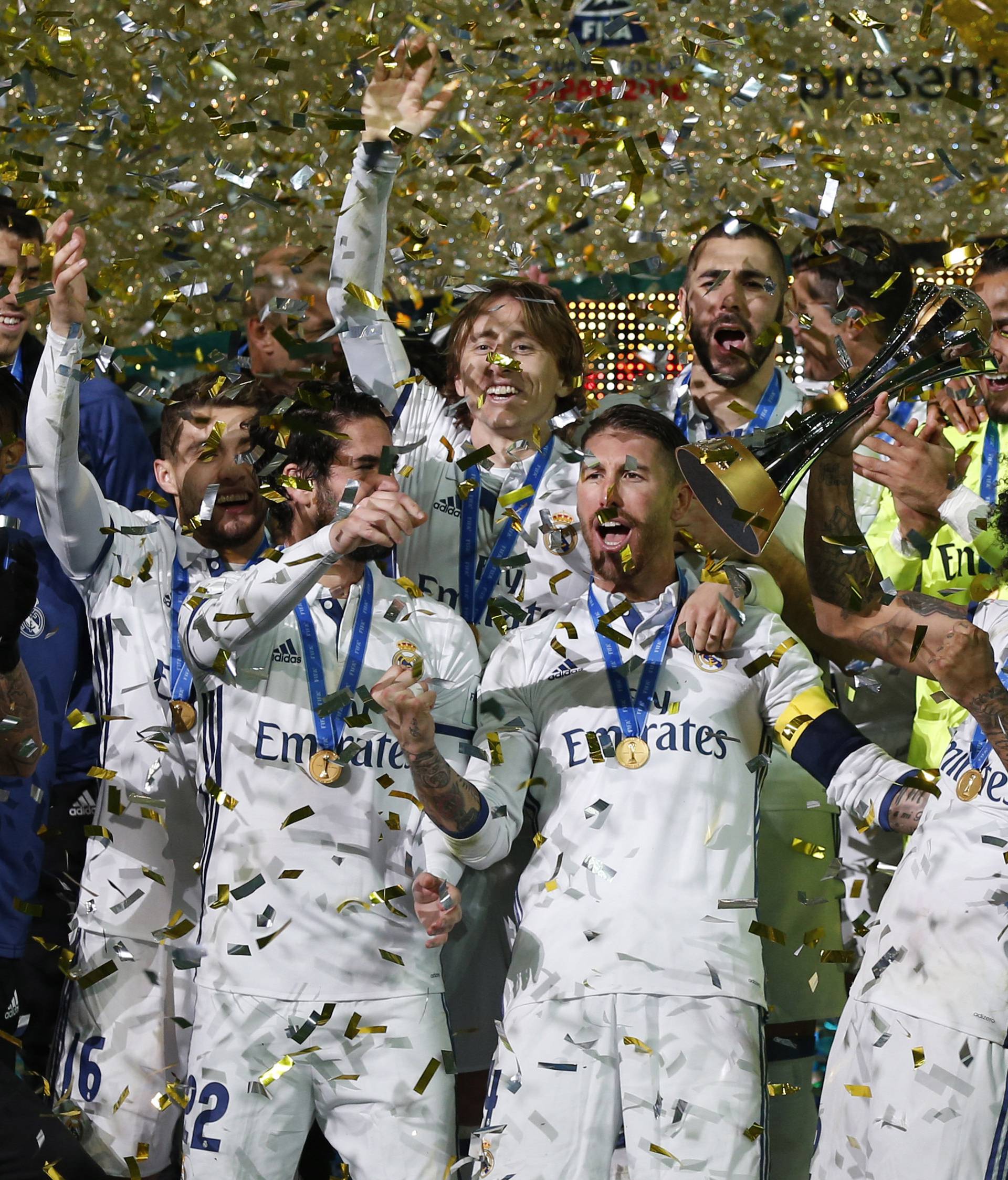 Real Madrid's Sergio Ramos and team mates celebrate winning the FIFA Club World Cup Final with the trophy