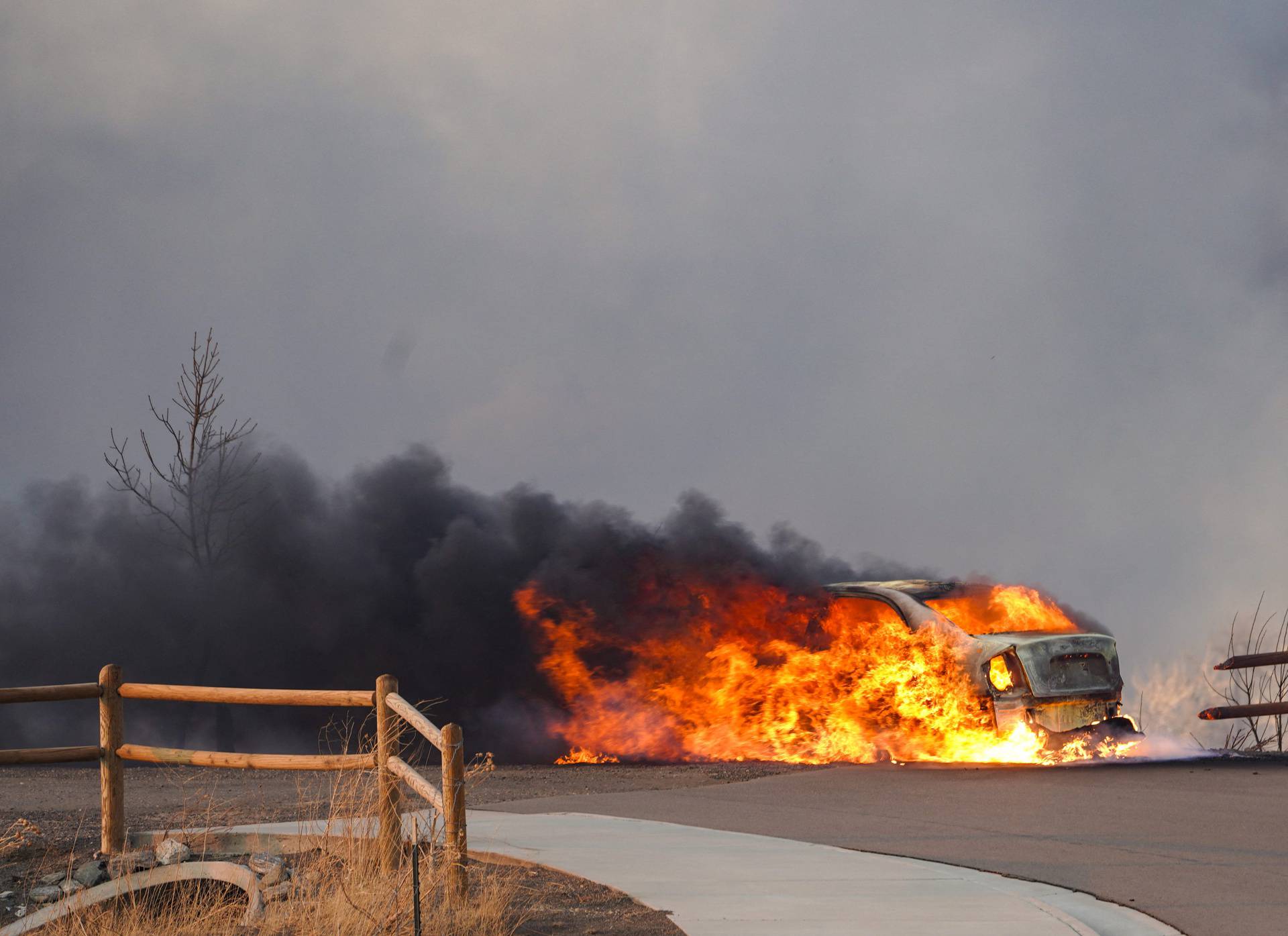 A car burns as a wind-driven wildfire forced evacuation of Superior suburb of Boulder