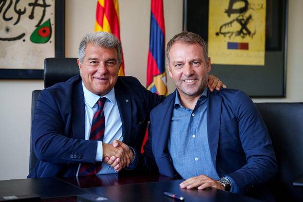 FC Barcelona's president Joan Laporta poses with newly signed coach Hansi Flick in Barcelona