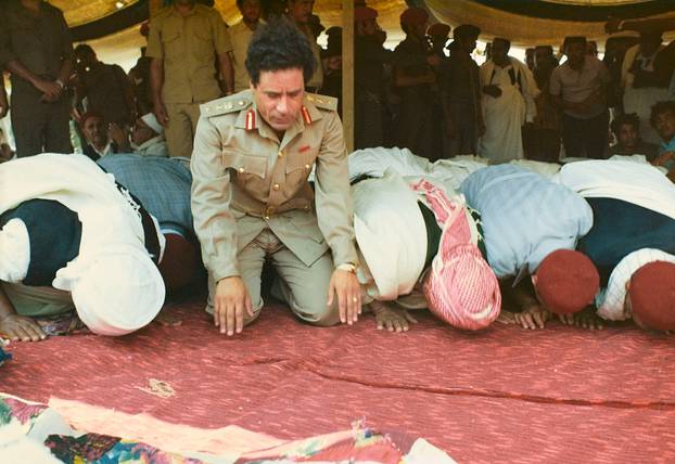 Muammar Gaddafi and Men praying - Sousa, Libya