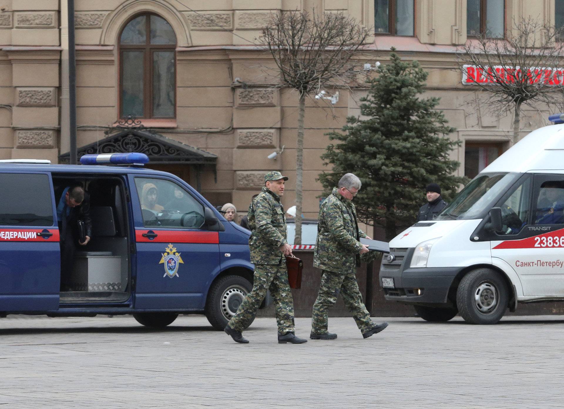 Members of security services walk past vehicle of Russia's Investigative Committee outside Sennaya Ploshchad metro station after explosion tore through train carriage in St. Petersburg metro system, in St. Petersburg