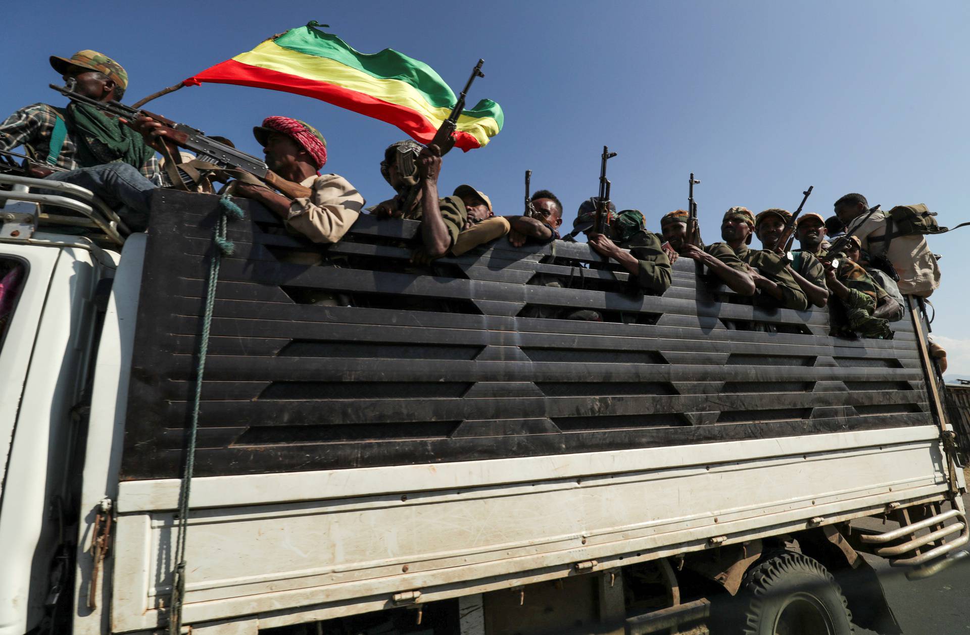 FILE PHOTO: Amhara region militiamen ride on their truck as they head to face the Tigray People's Liberation Front in Sanja