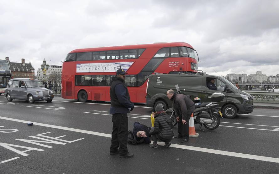 A man lies injured after a shottingt incident on Westminster Bridge in London