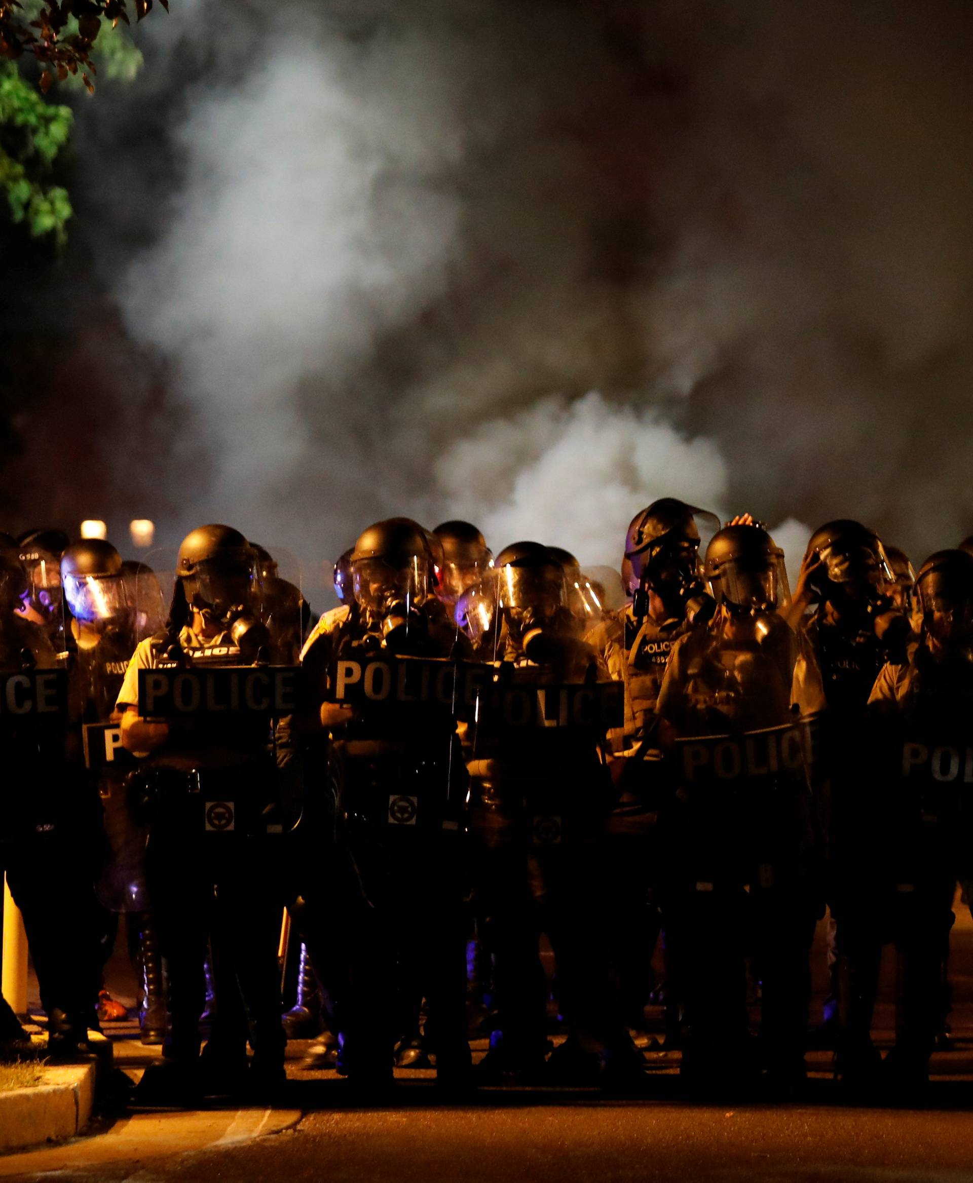 Law enforcement officials line a residential street where people protest following acquittal of Stockley in St Louis