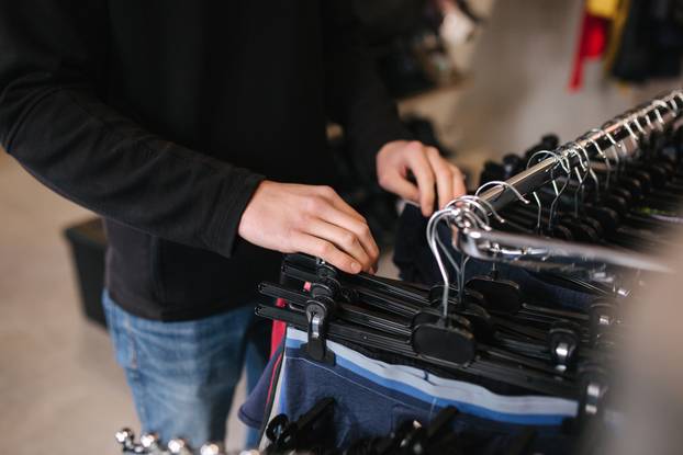 Man choosing underwear in clothing store. Close up